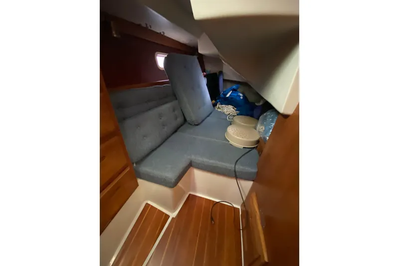 Slide: The Image of Cozy cabin interior of 1998 Catalina 36 MkII sailboat with blue cushions and wooden flooring. - 15