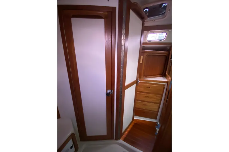Slide: The Image of Interior of 1998 Catalina 36 MkII sailboat with wooden cabinetry and storage. - 17