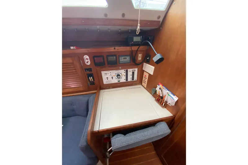 Slide: The Image of Navigation station inside a 1998 Catalina 36 MkII sailboat, featuring control panels and seating. - 20