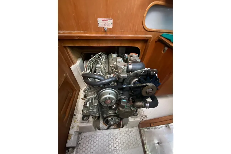 Slide: The Image of Engine compartment of a 1998 Catalina 36 MkII sailboat, showcasing mechanical components. - 21