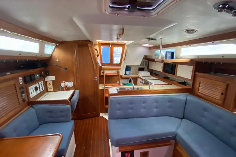Slide: The Image of Interior of a 1998 Catalina 36 MkII sailboat with cozy seating and wooden cabinetry. - 8