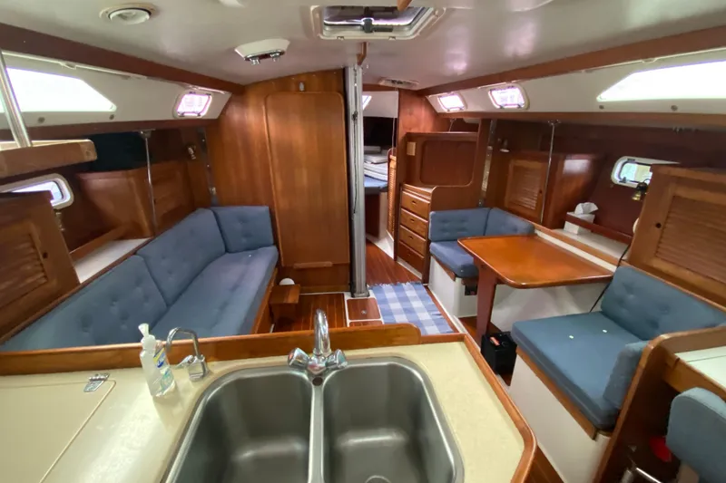 Slide: The Image of Interior of 1998 Catalina 36 MkII sailboat with wood finish and blue seating. - 9
