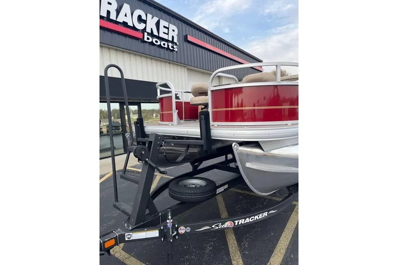 Slide: The Image of 2026 Sun Tracker Bass Buggy 16 XL Select pontoon boat on trailer at dealership. - 76