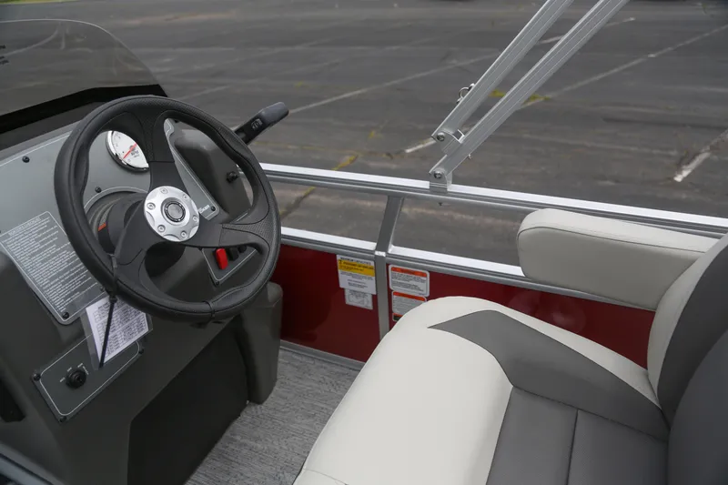 Slide: The Image of 2026 Sun Tracker Bass Buggy 16 XL Select steering console and seating detail. - 46