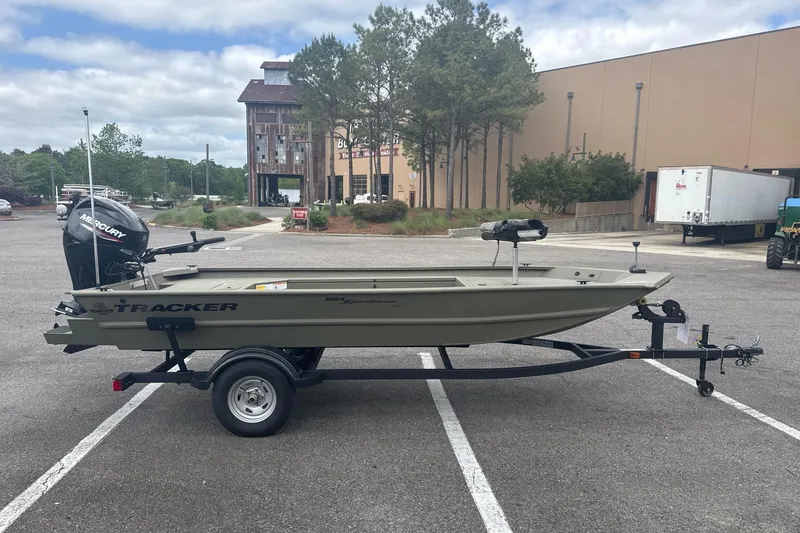 Slide: The Image of 2026 Tracker Grizzly 1654 T Sportsman boat on trailer in parking lot. - 2
