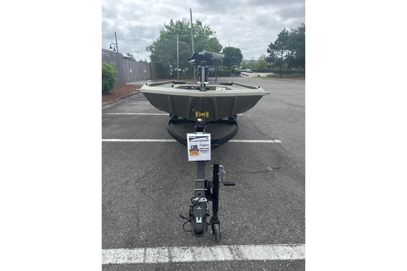 Slide: The Image of 2026 Tracker Grizzly 1654 T Sportsman boat on trailer in parking lot. - 3