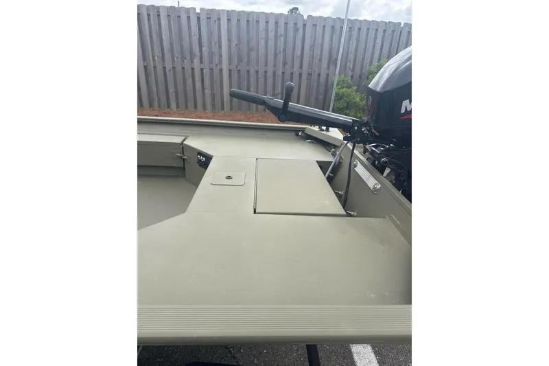Slide: The Image of 2026 Tracker Grizzly 1654 T Sportsman boat interior with motor and storage compartments. - 6