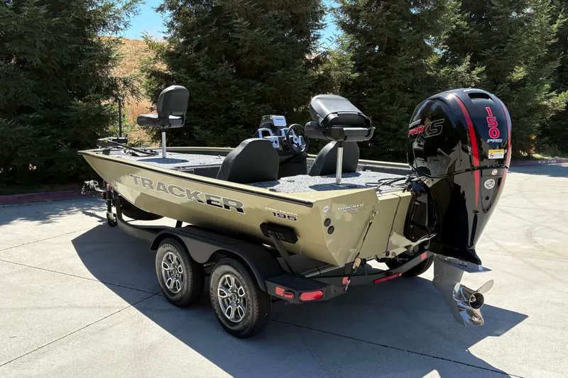 Slide: The Image of 2026 Tracker Pro Team 195 boat with powerful engine, parked outdoors. - 4