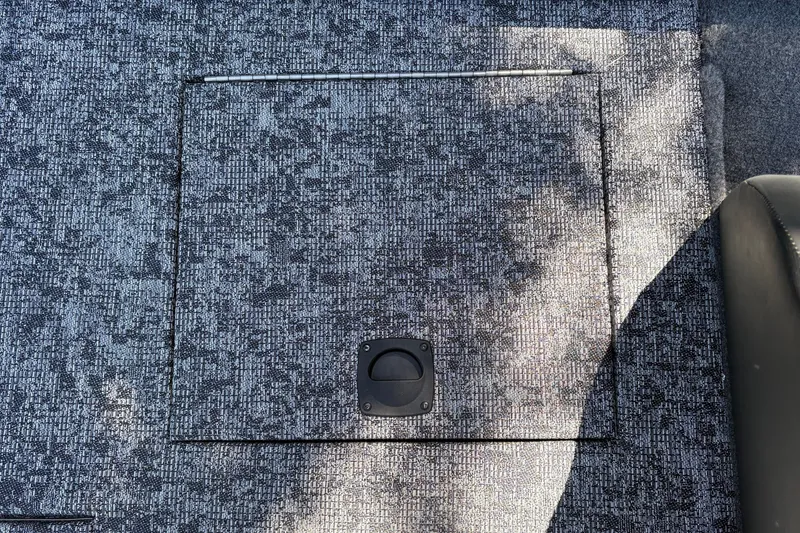Slide: The Image of Carpeted deck of 2026 Tracker Pro Team 195 boat with storage hatch. - 42