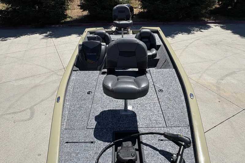 Slide: The Image of 2026 Tracker Pro Team 195 boat with seating and control panel, parked outdoors. - 16