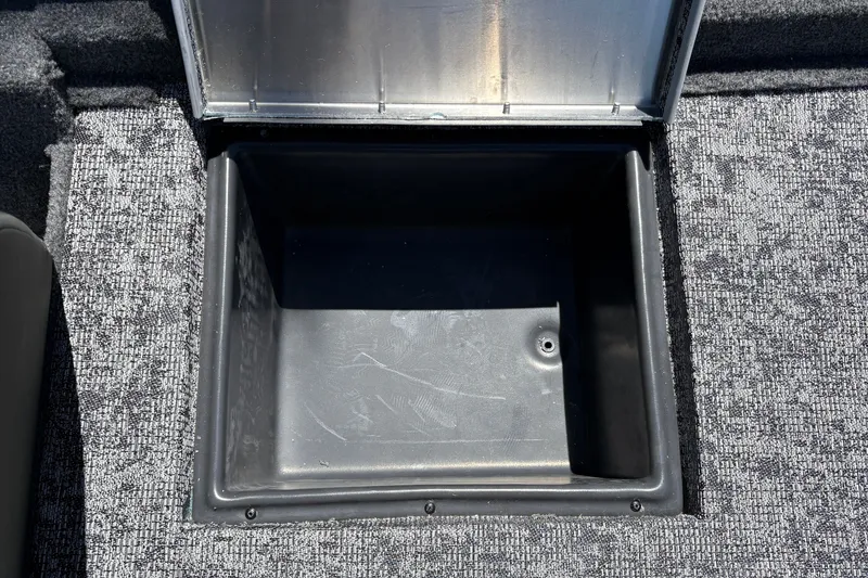 Slide: The Image of Open storage compartment in 2026 Tracker Pro Team 195 boat, featuring carpeted interior. - 32