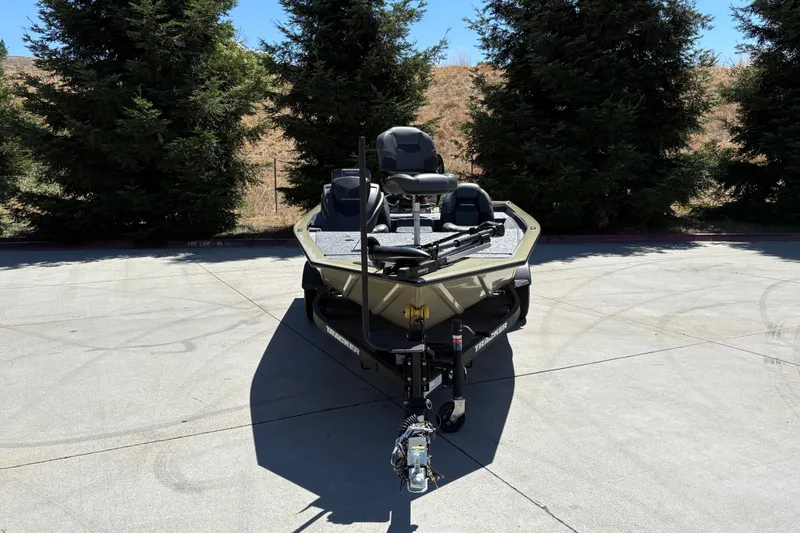 Slide: The Image of 2026 Tracker Pro Team 195 boat parked on concrete, surrounded by trees. - 10
