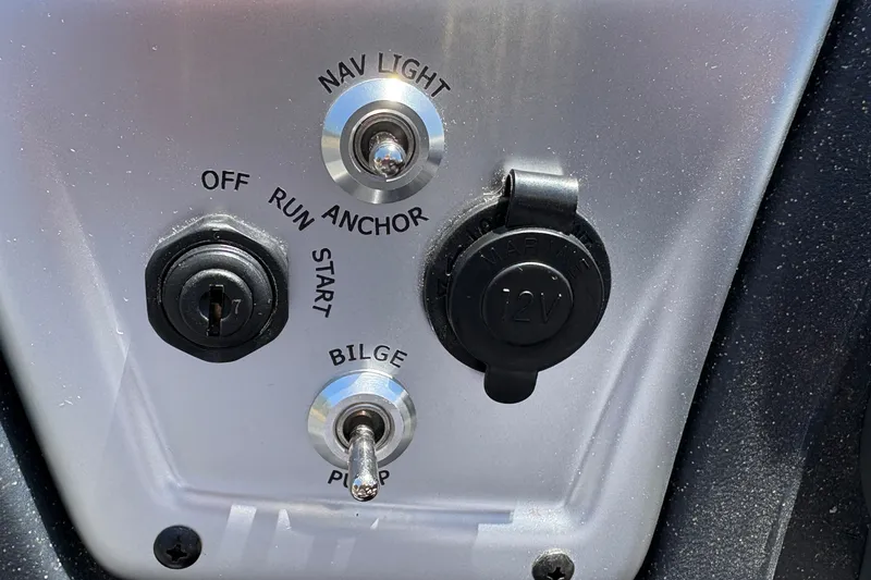 Slide: The Image of Control panel of 2026 Tracker Pro Team 195 boat with switches and 12V outlet. - 22