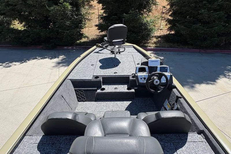Slide: The Image of 2026 Tracker Pro Team 195 boat interior with steering console and seating. - 19
