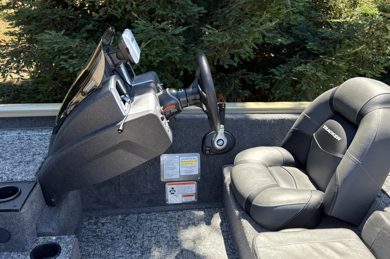 Slide: The Image of 2026 Tracker Pro Team 195 boat interior with steering wheel and cushioned seat. - 20