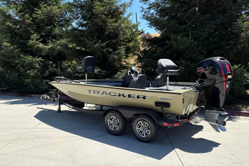 Slide: The Image of 2026 Tracker Pro Team 195 boat with powerful outboard motor, parked outdoors. - 9