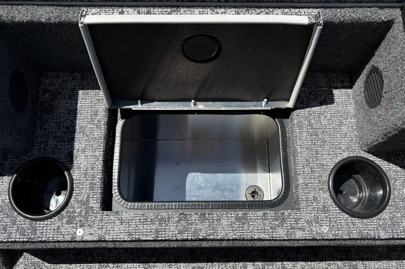 Slide: The Image of Open storage compartment on 2026 Tracker Pro Team 195 boat with cup holders. - 33