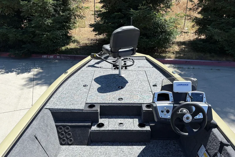 Slide: The Image of 2026 Tracker Pro Team 195 boat interior with steering wheel and fishing seat. - 18