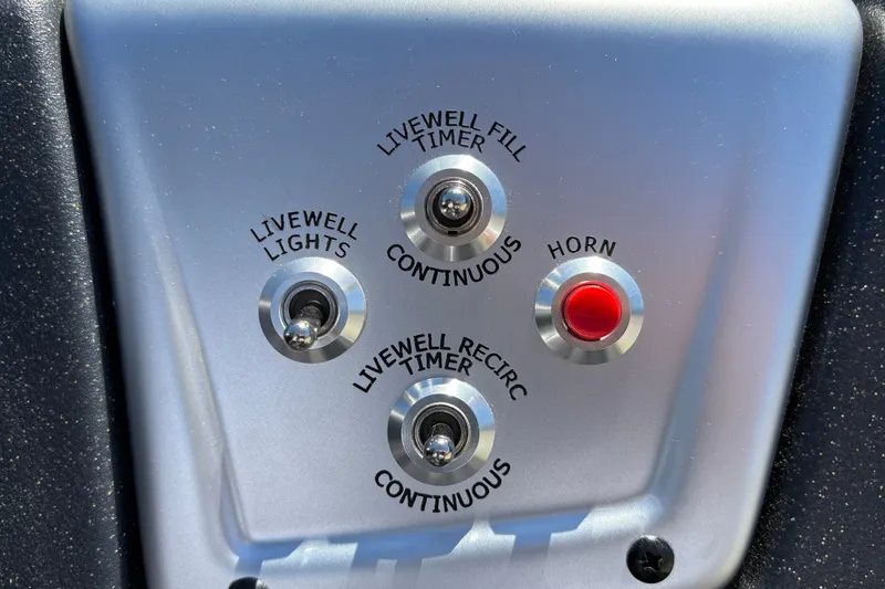 Slide: The Image of Control panel of 2026 Tracker Pro Team 195 boat with switches and horn button. - 24