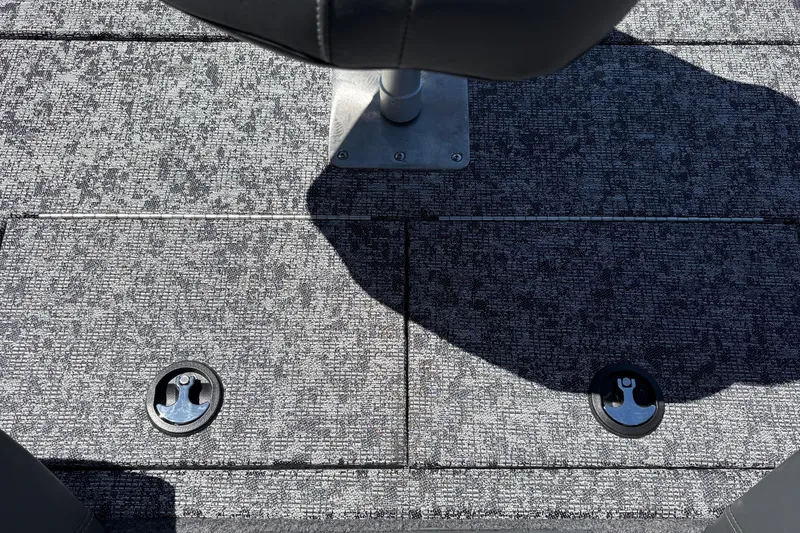 Slide: The Image of Carpeted deck of 2026 Tracker Pro Team 195 boat with seat base and storage hatches. - 38