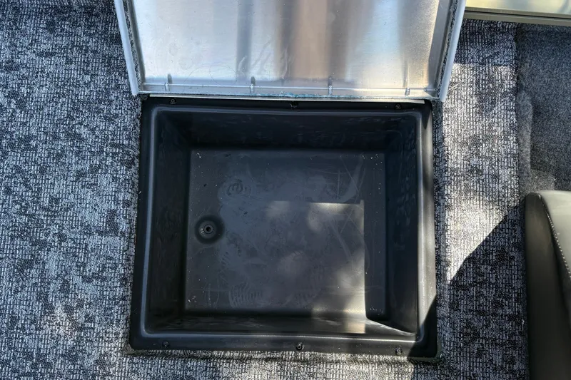 Slide: The Image of Open storage compartment in 2026 Tracker Pro Team 195 boat, featuring textured flooring. - 30