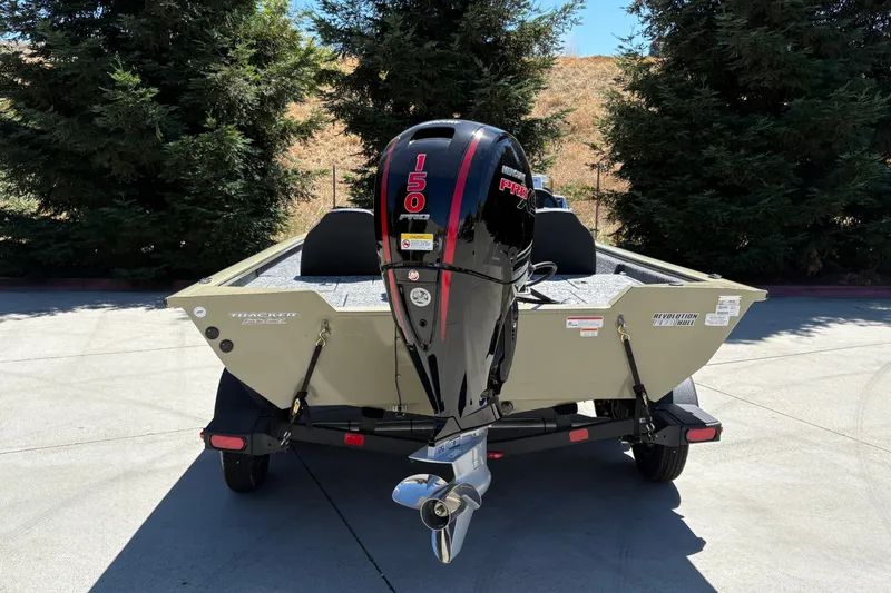 Slide: The Image of 2026 Tracker Pro Team 195 boat with powerful outboard motor, parked outdoors. - 12