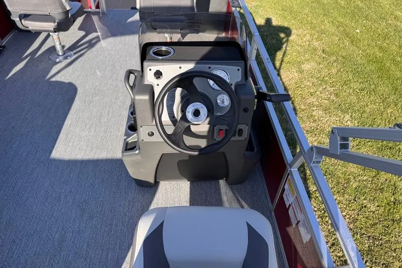 Slide: The Image of 2026 Sun Tracker Bass Buggy 18 DLX steering console with gauges and seating. - 88