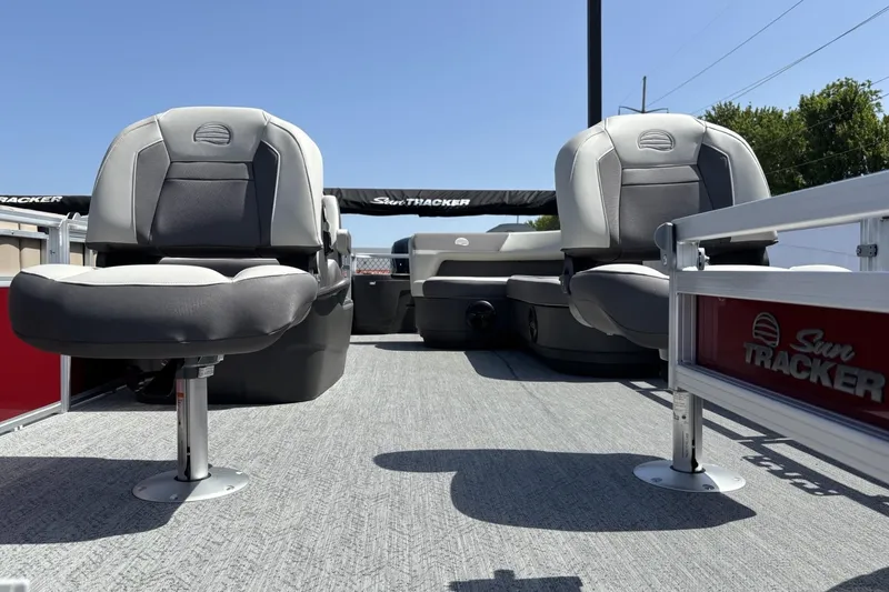 Slide: The Image of 2026 Sun Tracker Bass Buggy 18 DLX pontoon boat interior with seating and branding. - 1