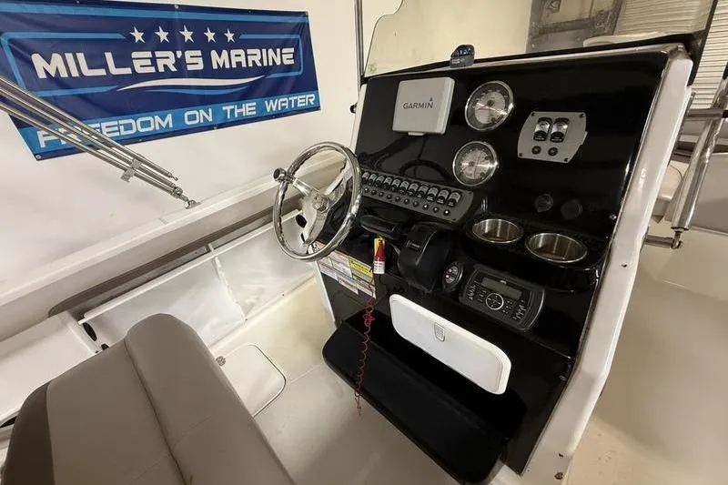 Slide: The Image of Boat dashboard with Garmin navigation, steering wheel, and controls, 2018 Hurricane model. - 10