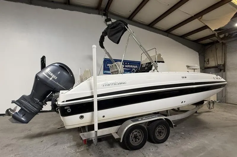 Slide: The Image of 2018 Hurricane boat on trailer with Yamaha outboard motor in a garage. - 2