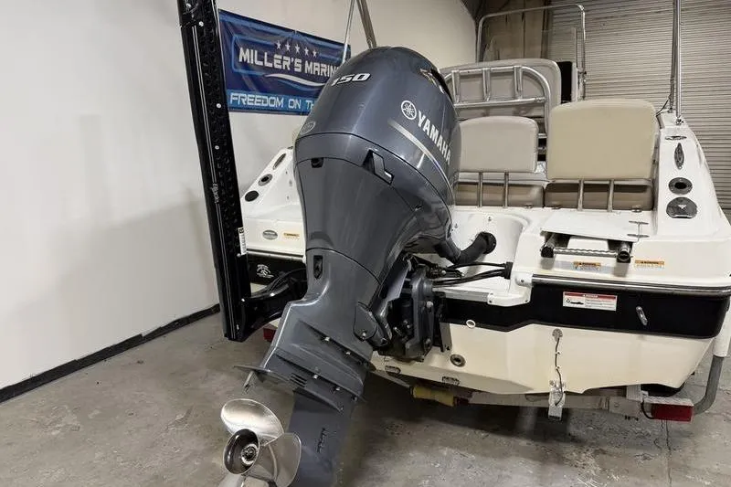Slide: The Image of 2018 Hurricane boat with Yamaha 150 outboard motor in a garage setting. - 3