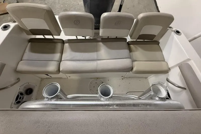 Slide: The Image of 2018 Hurricane boat seating area with beige cushions and cup holders. - 5