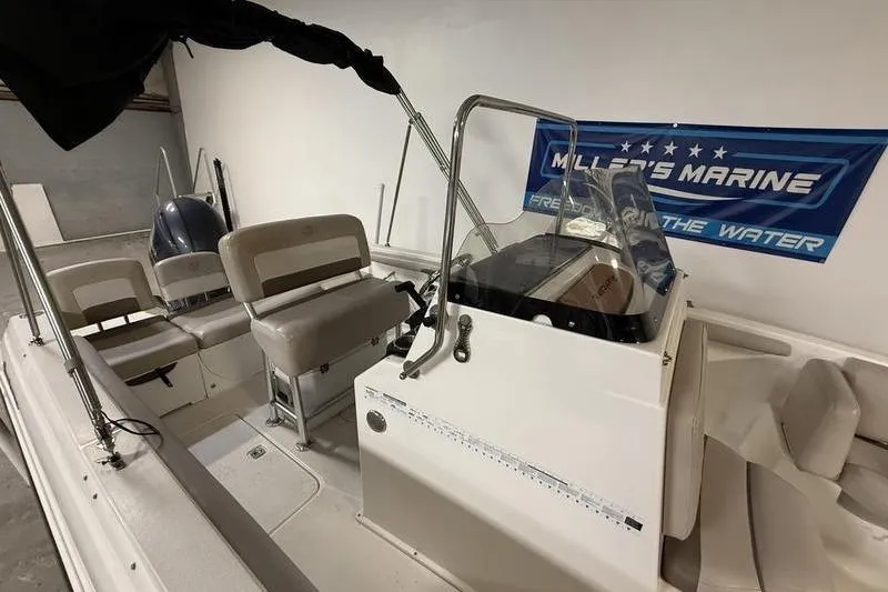 Slide: The Image of 2018 Hurricane boat interior with seating and control console in showroom. - 6