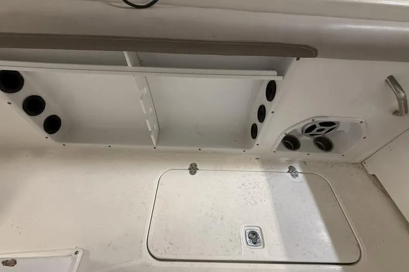 Slide: The Image of Interior of a 2018 Hurricane boat showing storage compartments and speaker system. - 7