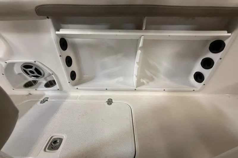 Slide: The Image of 2018 Hurricane boat interior storage compartment with cup holders and speaker. - 8