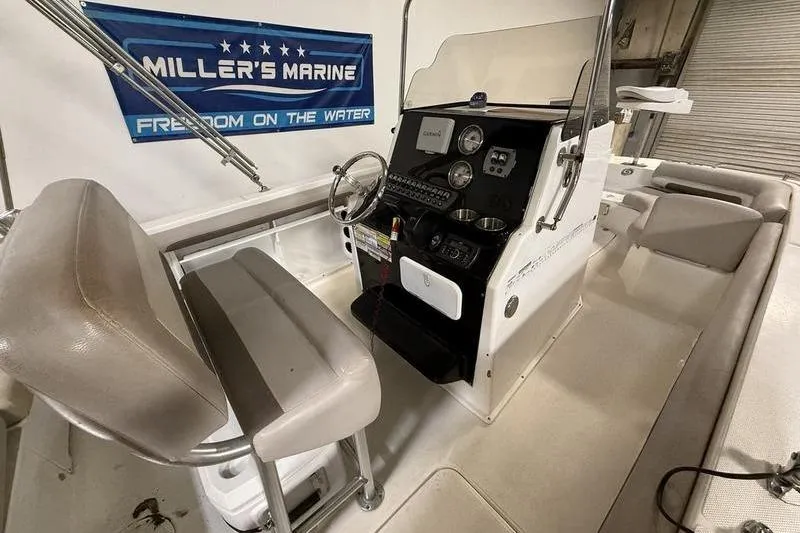 Slide: The Image of Interior of a 2018 Hurricane boat with steering console and seating. - 9