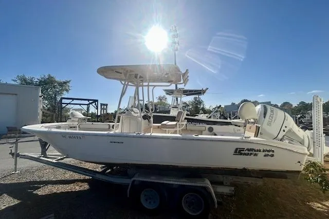 Slide: The Image of 2023 Carolina Skiff 24 Ultra Elite boat on trailer under bright sun. - 2