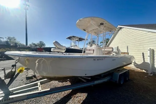 Slide: The Image of 2023 Carolina Skiff 24 Ultra Elite boat on trailer, parked outdoors under clear sky. - 3