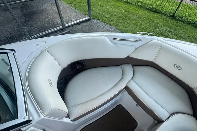 Slide: The Image of Cobalt 200 boat interior, 2014 model, featuring white cushioned seating and cup holders. - 13