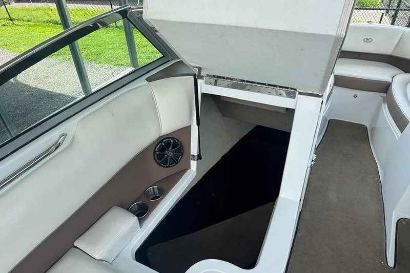 Slide: The Image of 2014 Cobalt 200 boat interior with open storage compartment and seating area. - 16