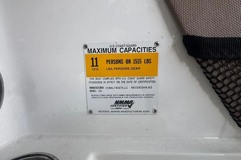 Slide: The Image of U.S. Coast Guard capacity label for 2014 Cobalt 200 boat, 11 persons or 1515 lbs. - 18