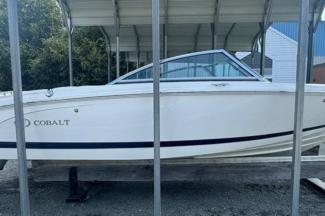 Slide: The Image of 2014 Cobalt 200 boat under a metal canopy, side view. - 2