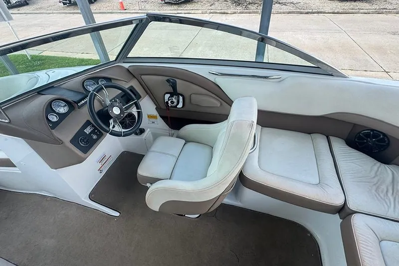 Slide: The Image of 2014 Cobalt 200 boat interior with steering wheel, dashboard, and seating area. - 7