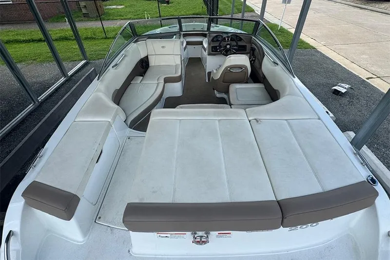 Slide: The Image of 2014 Cobalt 200 boat interior with spacious seating and modern dashboard design. - 9
