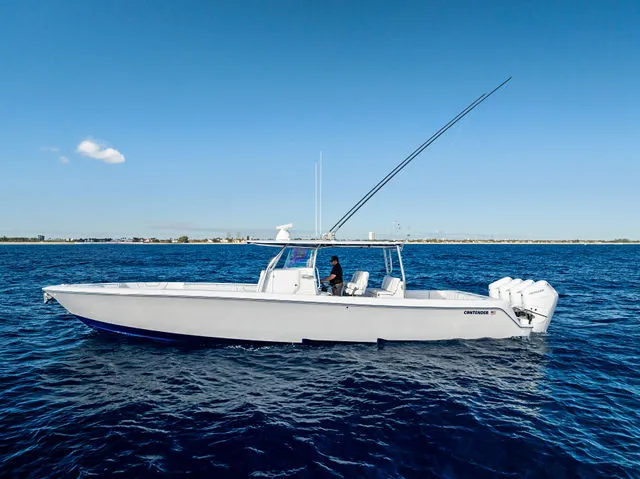 Slide: The Image of 2021 Contender 44 ST boat with red and white interior at a dock. - 11