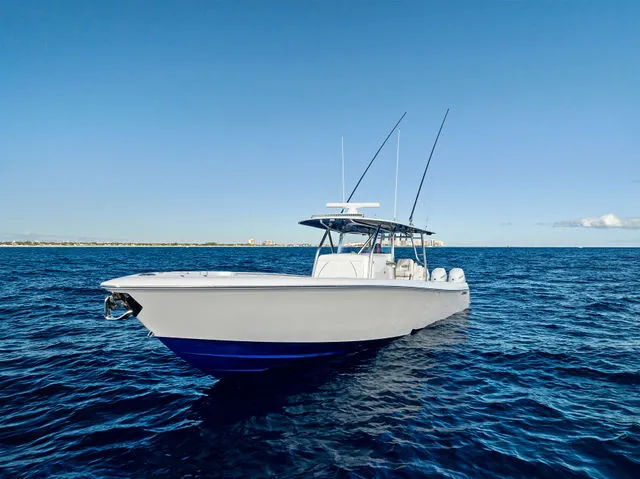 Slide: The Image of 2021 Contender 44 ST boat with open storage compartment, red and white interior, docked by water. - 13