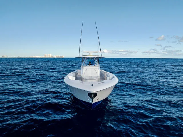 Slide: The Image of 2021 Contender 44 ST boat interior with red accents and speakers under blue sky. - 14
