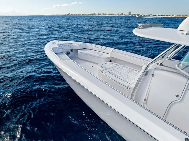 Slide: The Image of 2021 Contender 44 ST boat with red seating, docked by the water. - 17