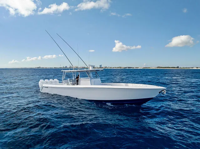 Slide: The Image of 2021 Contender 44 ST boat with red seating, docked at marina with multiple engines. - 19