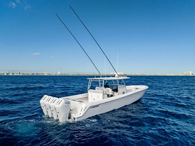 Slide: The Image of 2021 Contender 44 ST boat with red seating and triple outboard engines at a marina. - 20